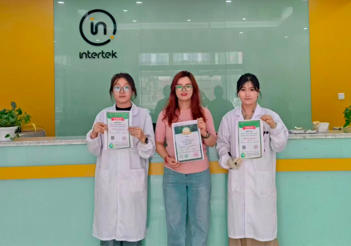 Three Intertek China colleagues hold up their donation certificates. 