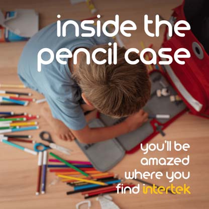 A child sitting over a pencil case with pencils scattered along the floor