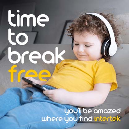 A young child sitting on a couch with headphones and a tablet